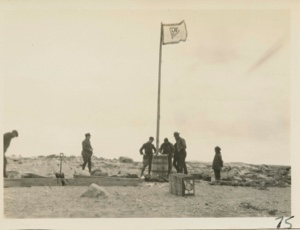 Image of Men around flag pole